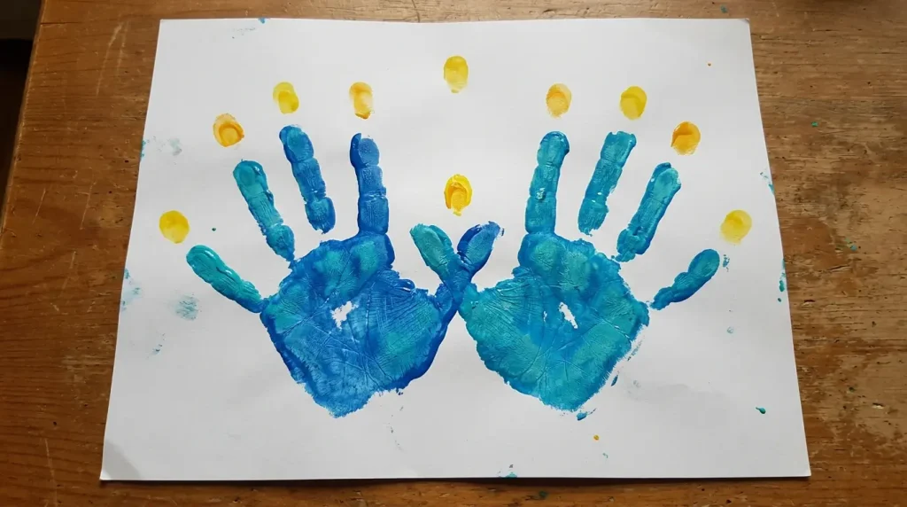 Handprint menorah with thumbs overlapping as the shamash
